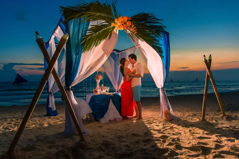 Luxury safari lodge- couple enjoy an intimate dinner on the beach
