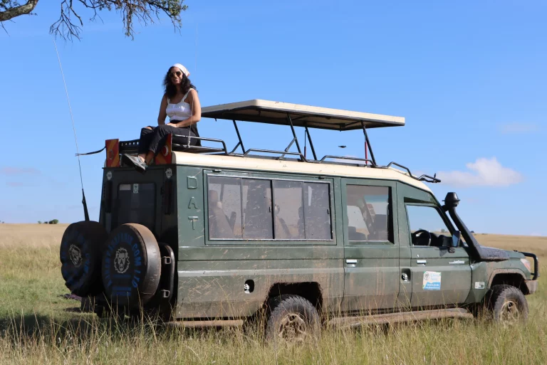 Multi centre holidays- a client seated on top of a safari van