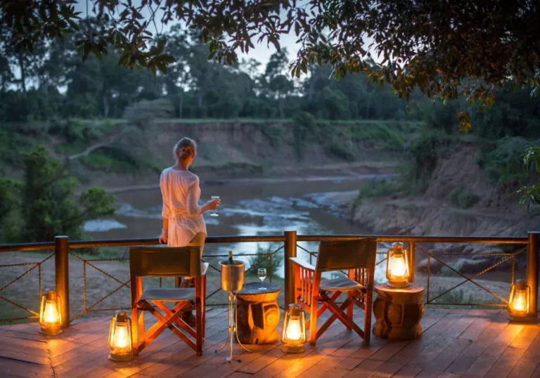 Multi destination holiday- a woman on a deck marvelling at the Mara river