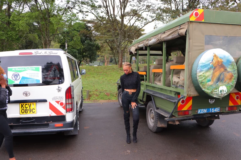 Kenya safari in august- woman poses for a pic before driving off for a game drive in the Mara