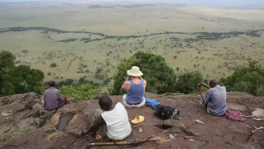 Typical day- tourists seated on top of an observation hill in Masai Mara