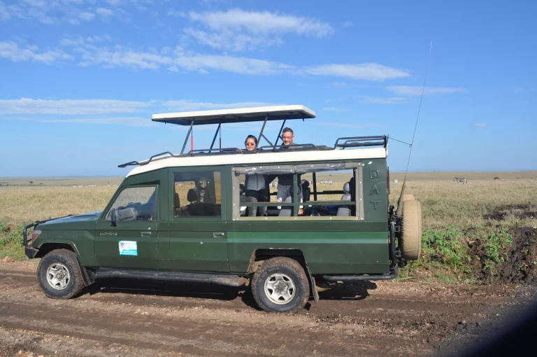Game drive-tourists standing inside our safari van pose for a pic