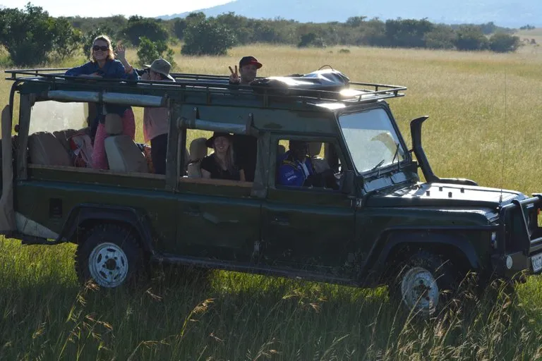 Holidays with multiple destinations- our clients on a game drive in the Mara