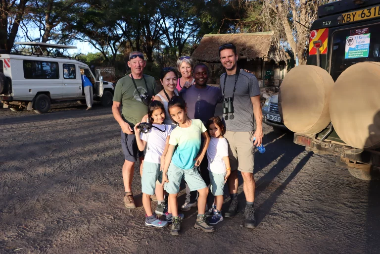 October in South Africa- tourists and their guide pose for a picture after a game drive