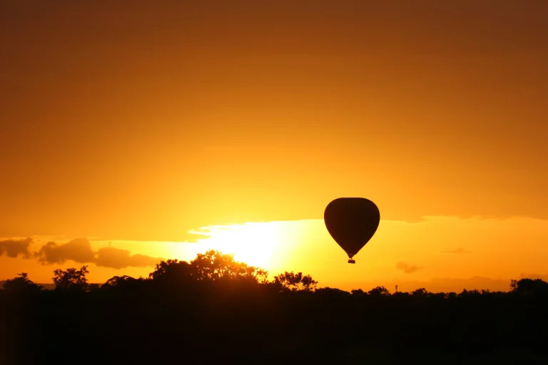 Kenya safari October- a hot air balloon floating above the Mara at sunrise