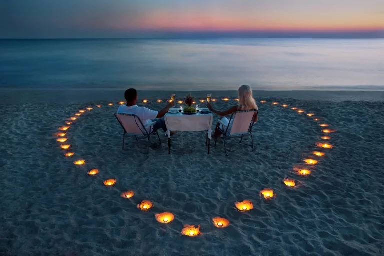 Warmest place in january- a couple enjoys a romantic candle-lit dinner on the beach