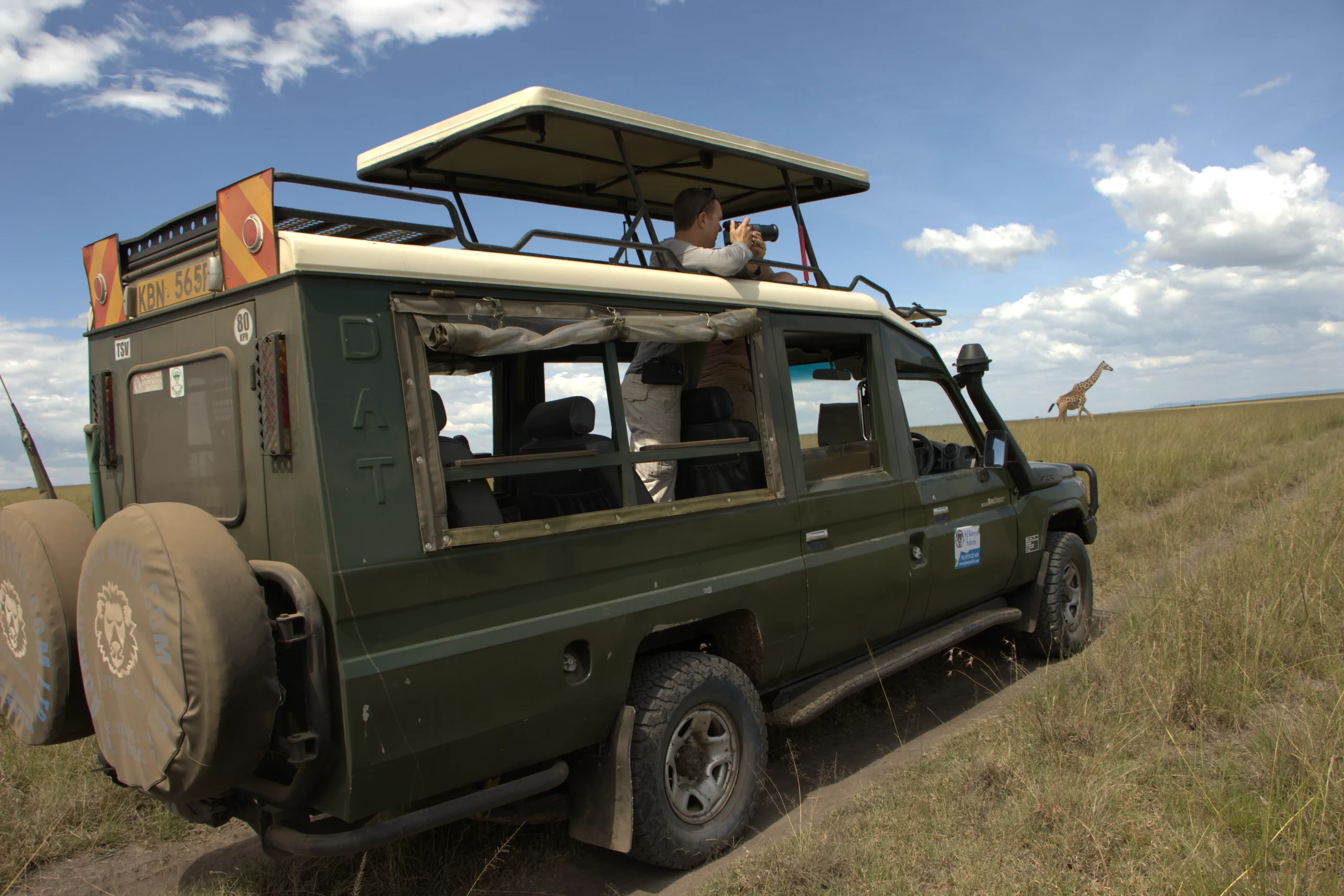 Ajkenyasfaris.com land cruiser in masai mara for the 2024 wildebeest migration safari