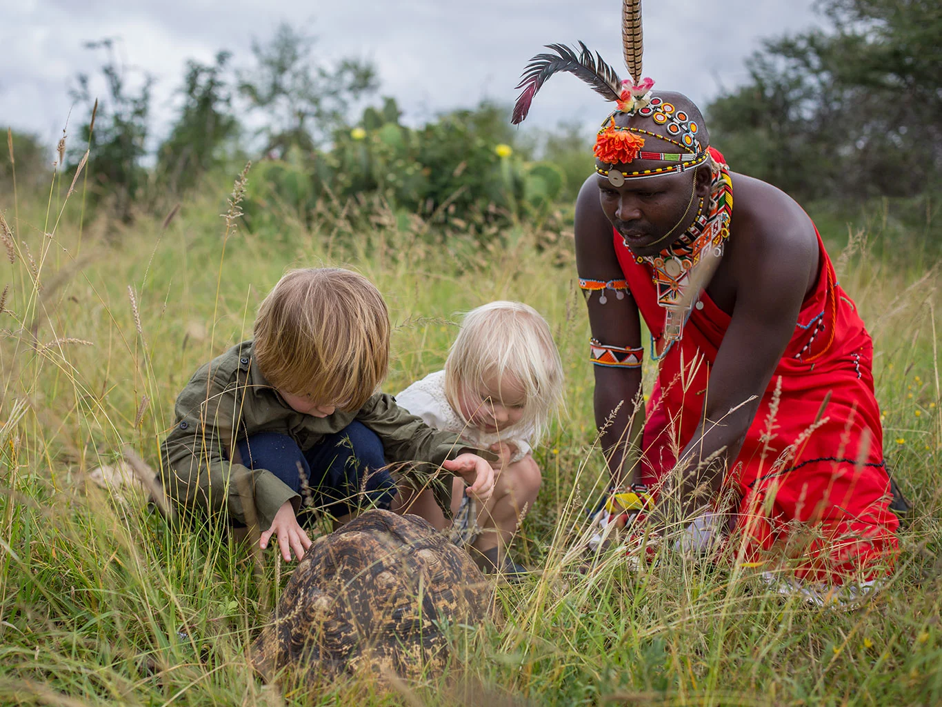 kenya family holidays - a family with a local Masai Guide on walking safari in Amboseli.