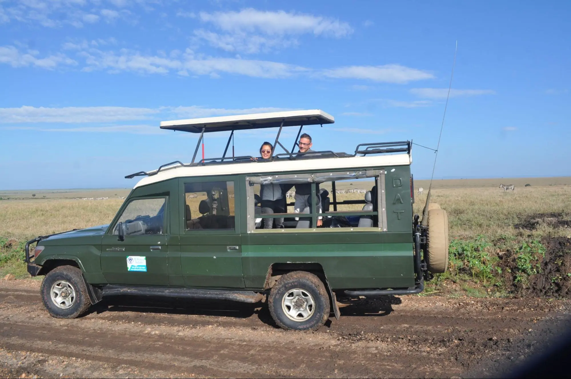 A safari vehicle suitable for holidays to Kenya safari with an open roof and sturdy wheels.