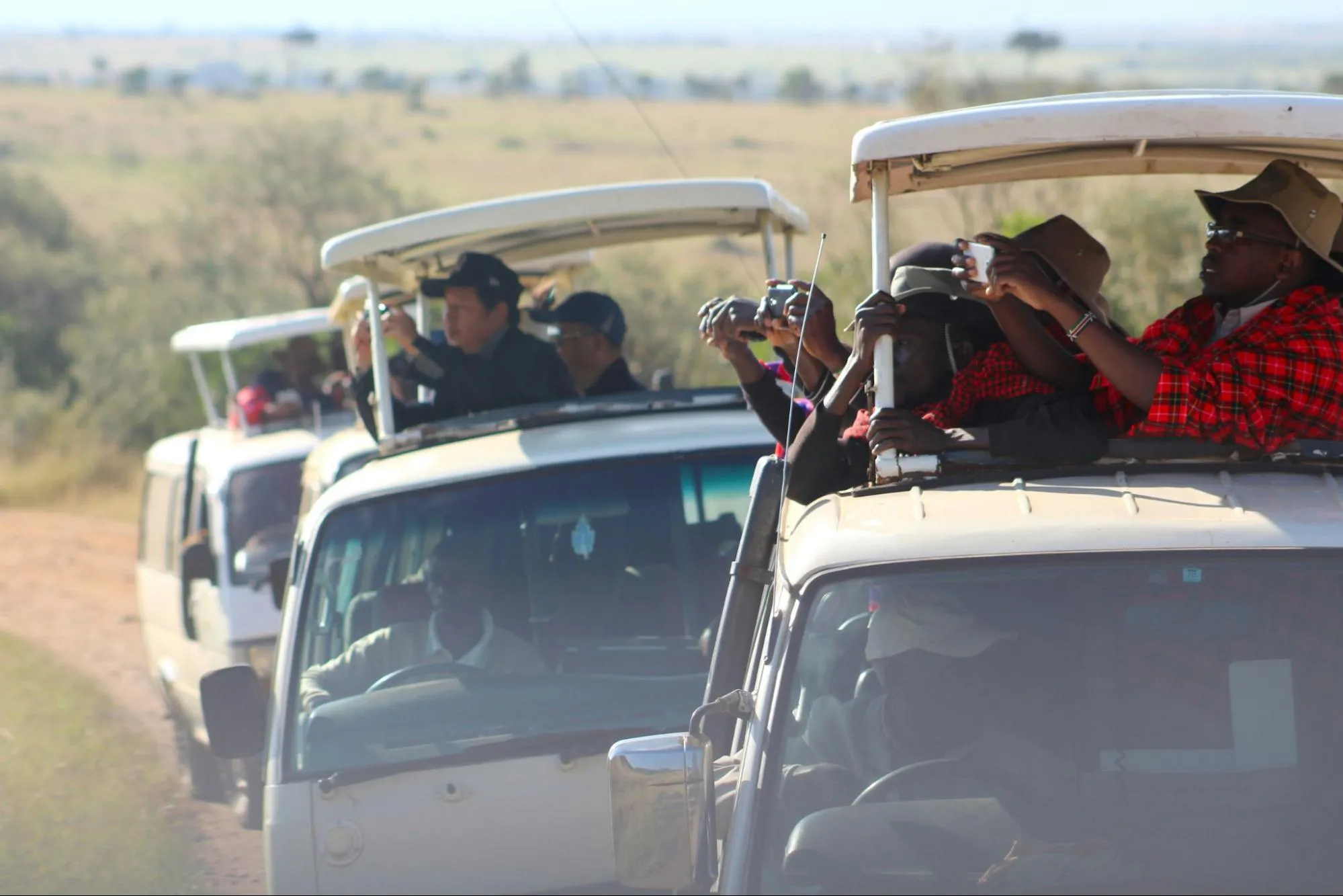 A diverse group of individuals enjoying an African jungle safari adventure in a vehicle