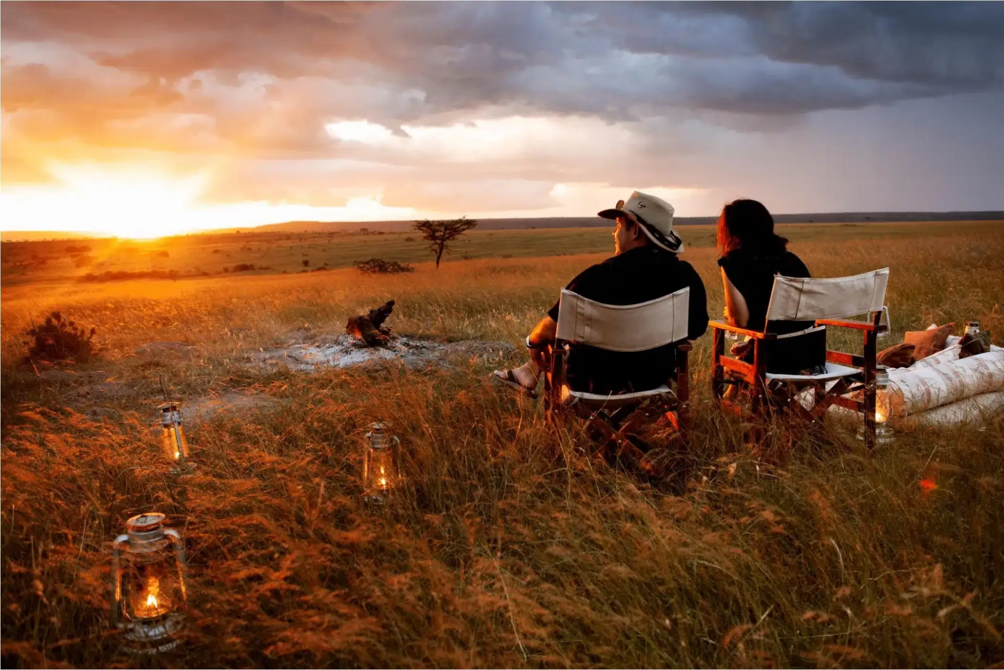 How to calculate the cost of safari in Kenya - a couple enjoying a sundowner in the wilderness