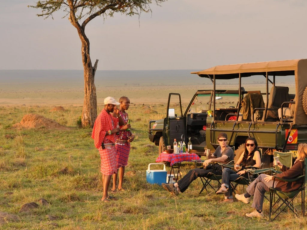 A group of people on a safari trip in Kenya in August, enjoying the wildlife and the ideal weather