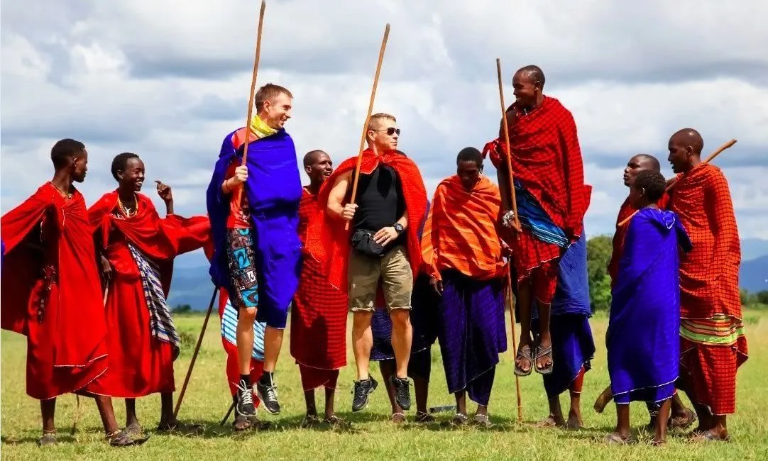 Cost of a cultural safari Kenya price - tourists interacting with Masai Morans