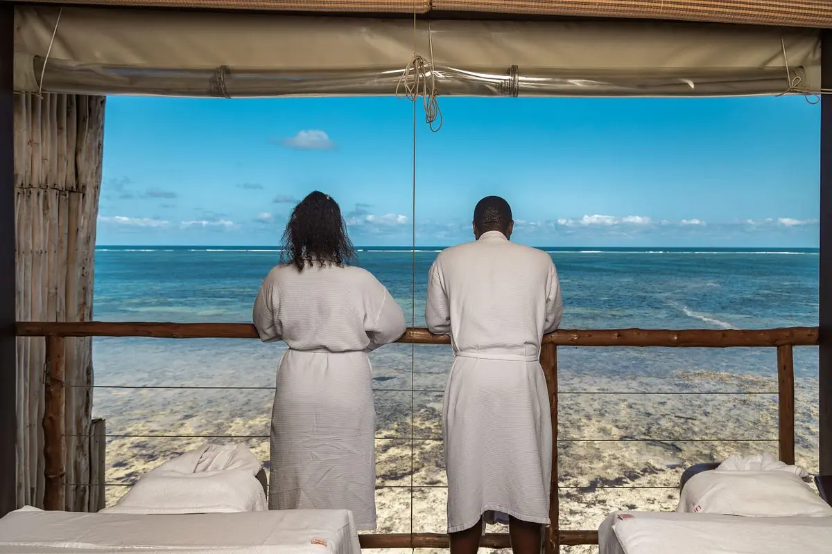 :Best all inclusive resort in Kenya - a couple at prideinn paradise beach resort and Spa in Diani beach Kenya.