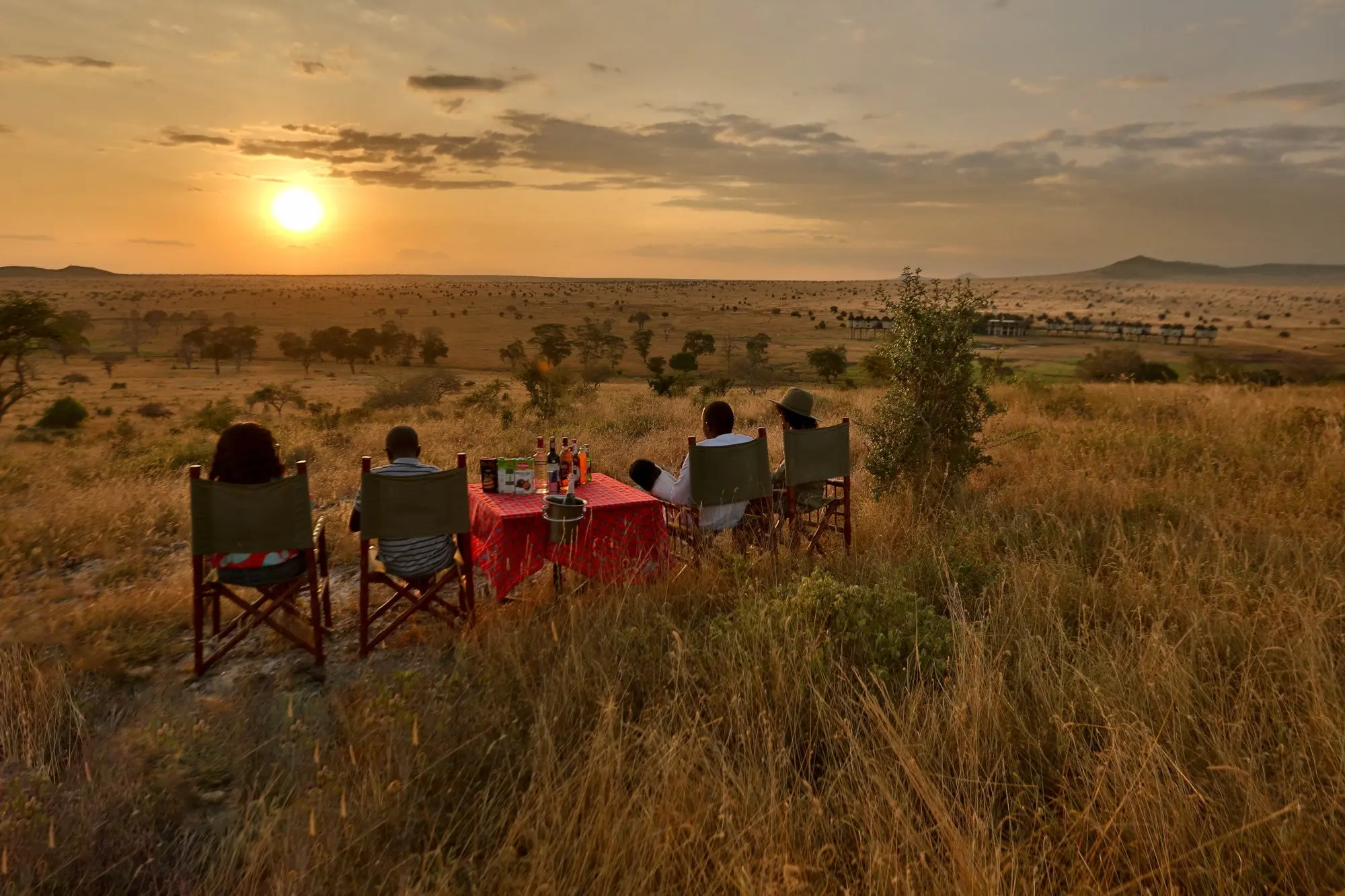 Bush meals on a luxury safari in Kenya - guests enjoying their evening in the Tsavo bush