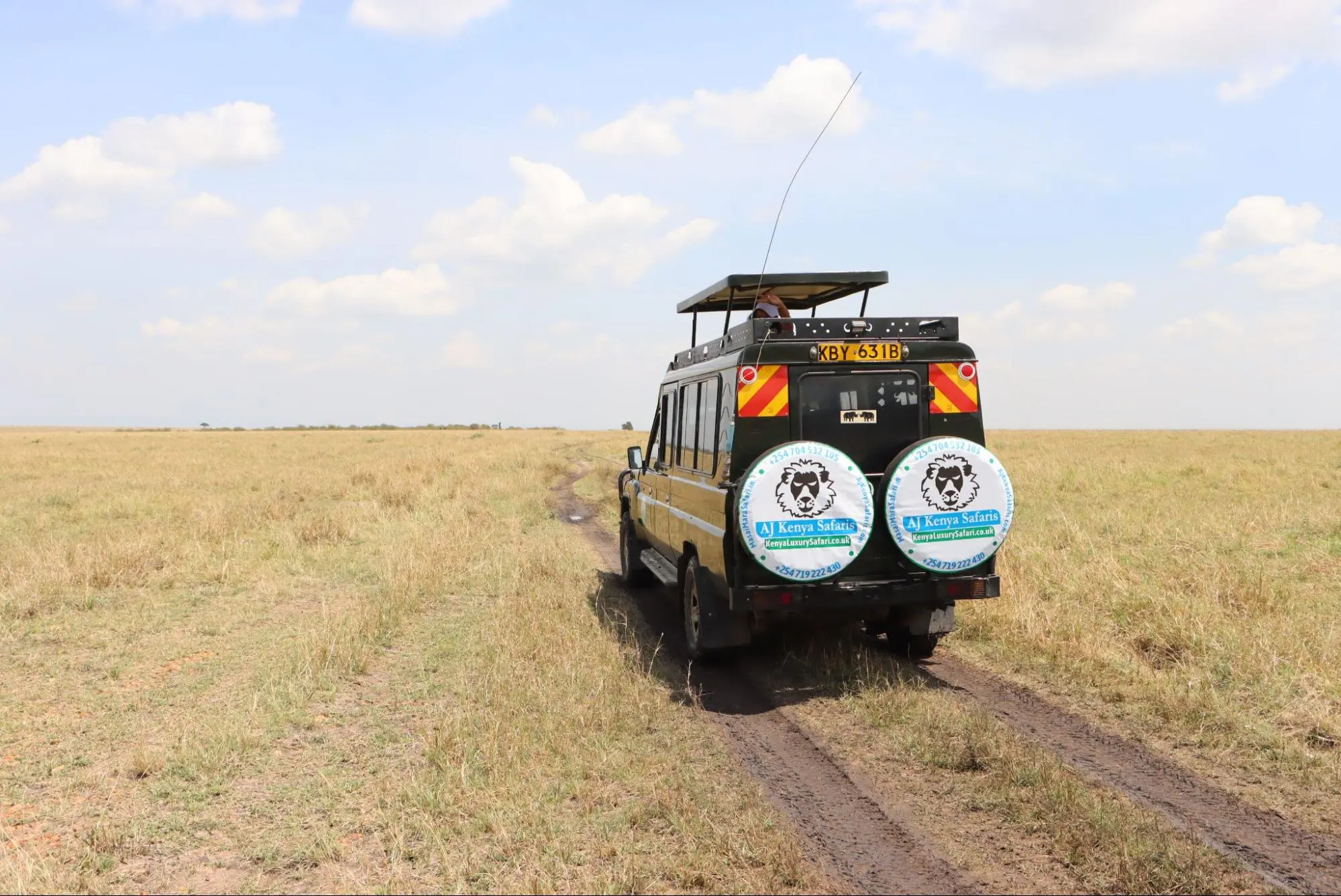 A safari vehicle driving through the Masai Mara National Reserve in Kenya - Safari Holidays Kenya