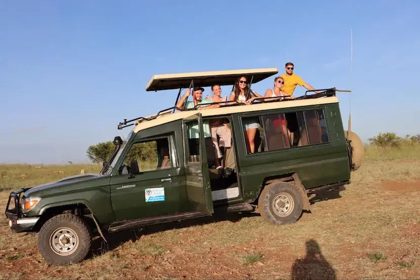 Joining a group for Cheap Kenya Holidays - Tourists in a safari vehicle