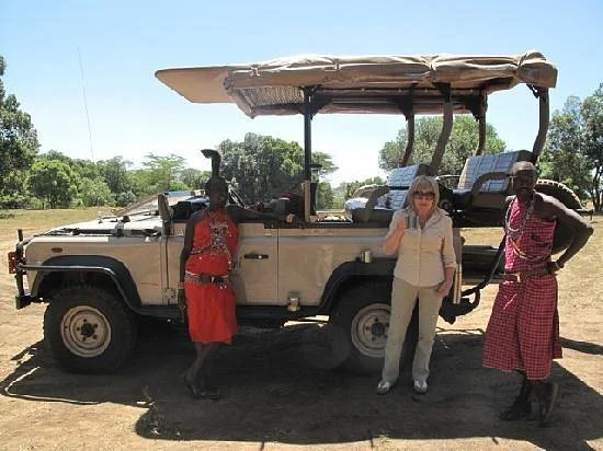 A group of people on a safari trip in Kenya in August, enjoying the wildlife and the ideal weather